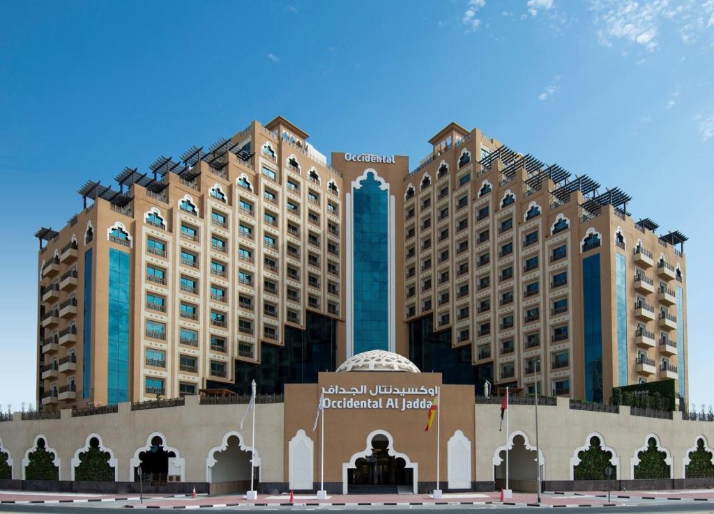 two large buildings with a sign in front of it at Occidental Al Jaddaf, Dubai in Dubai
