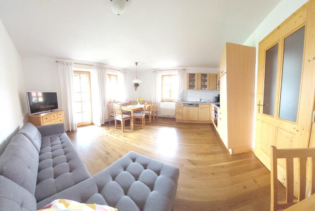 a large living room with a couch and a table at Weslhof in Attersee am Attersee