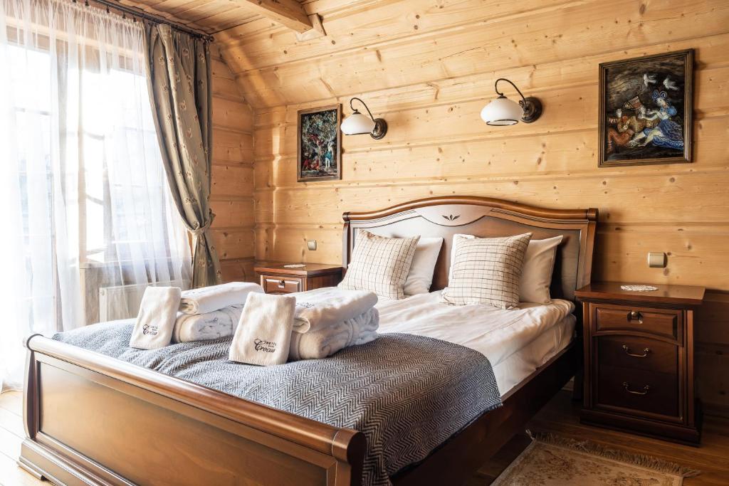 a bedroom with a bed with pillows on it at Dom Crocus in Zakopane