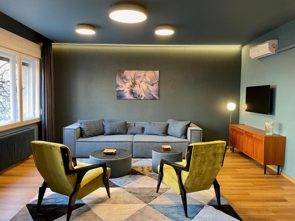 a living room with a couch and two chairs at Dohany utca 1b ,Luxury apartment in Center in Budapest