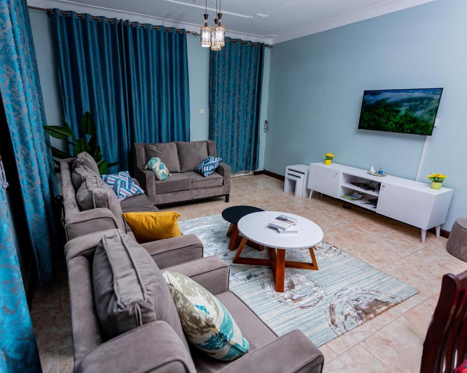 a living room with two couches and a table at The Mbuya Residence in Kampala