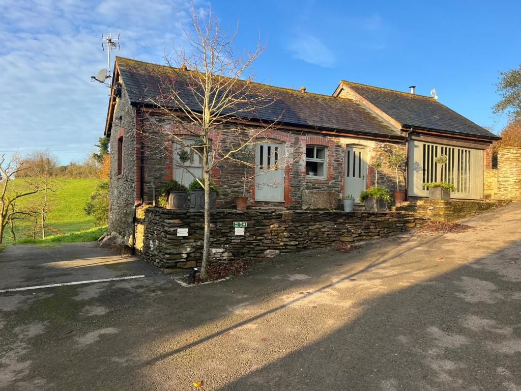 an old brick house on the side of a road at Charming Countryside Cottage in Ivybridge