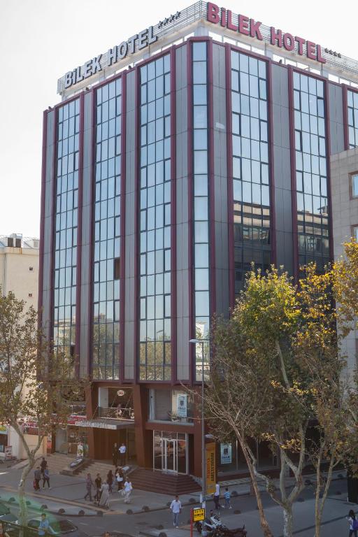 a tall red building with a black hotel sign on it at Bilek Istanbul Hotel in Istanbul