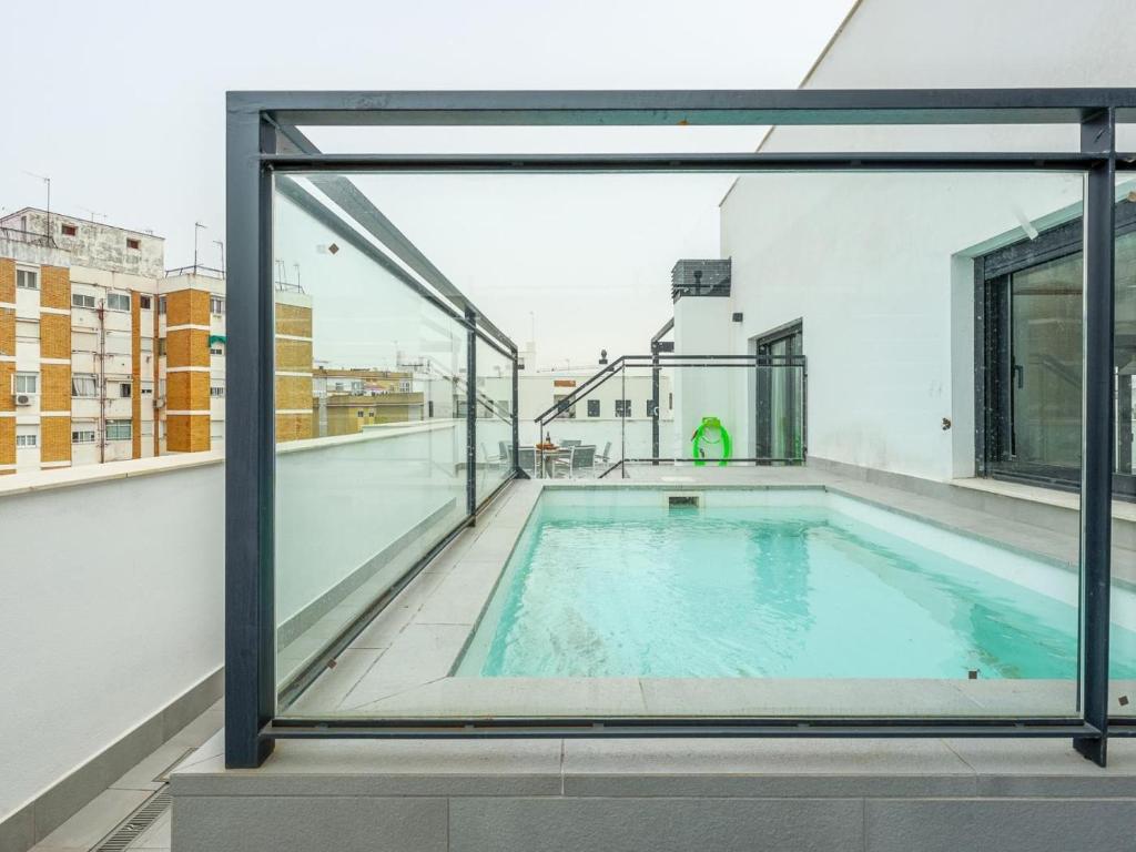 an indoor swimming pool on the roof of a building at Tejares Sevilla Luxury Penthouse en Triana - gran terraza, piscina & parking privados in Seville