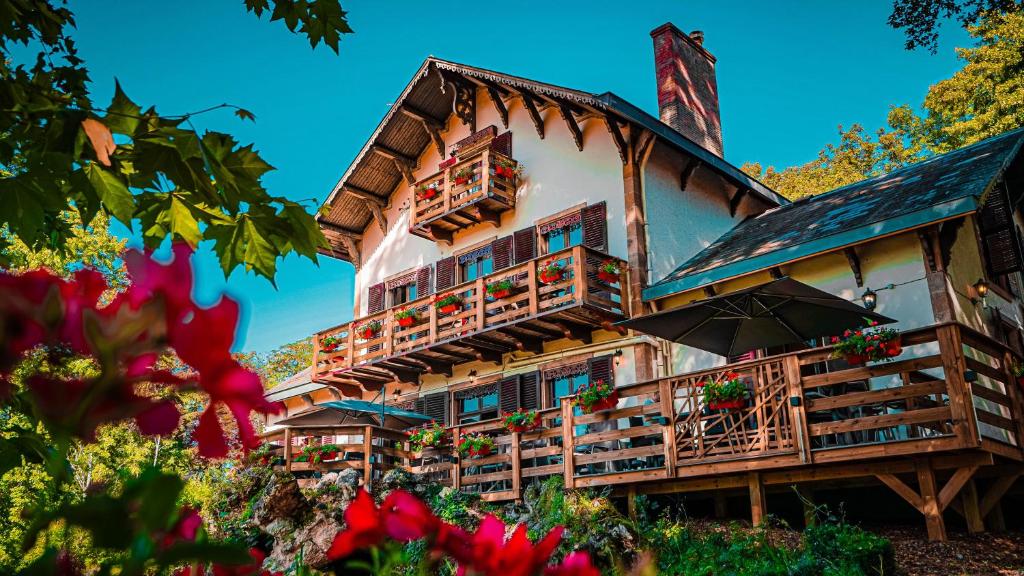 a large building with balconies and an umbrella at Le Chalet Montégut in Moulins