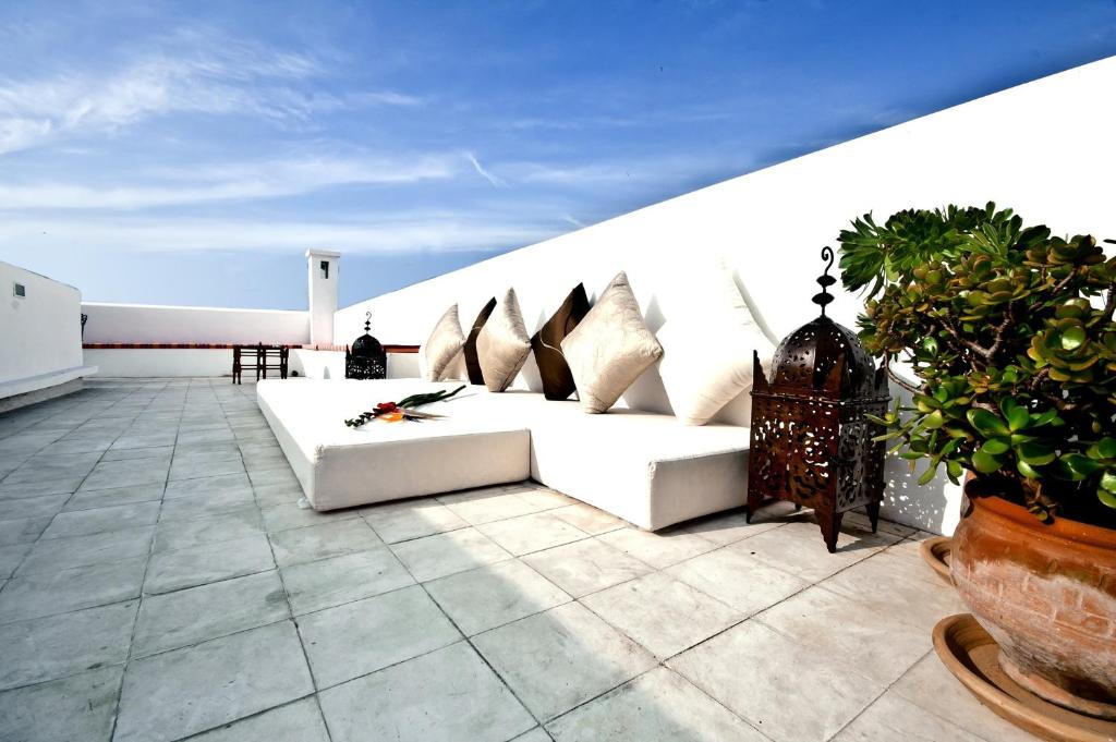 a white couch sitting on top of a roof at Riad El Maâti in Rabat