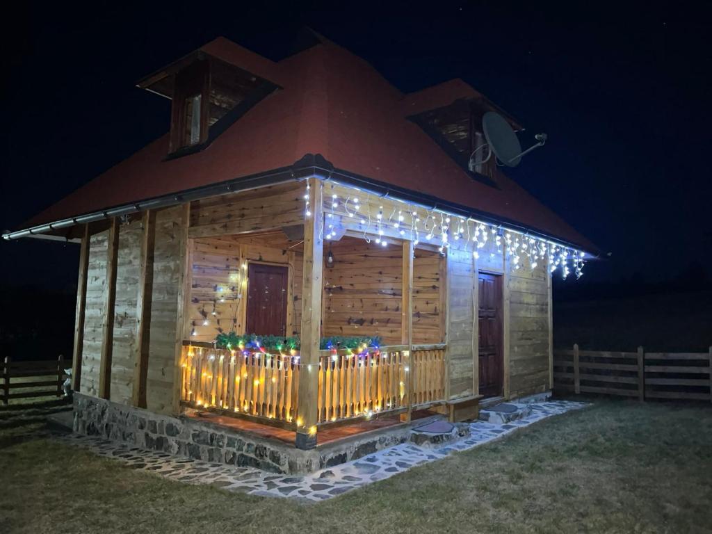 a log cabin with christmas lights on it at Vila Sofija Tornik in Ribnica