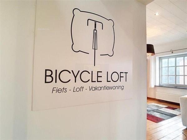 a sign on a wall in a room at Fietsloft - Bicycle loft in Oudenaarde