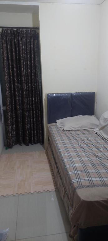 Säng eller sängar i ett rum på Apartment pancoran