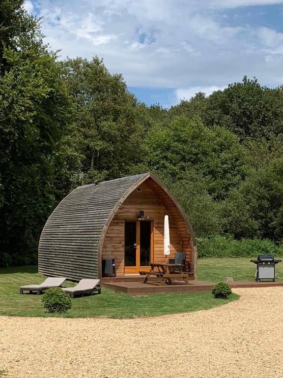 une petite cabane en bois avec un banc et une table dans l'établissement Chalet - Moulin du Squiriou, à Berrien