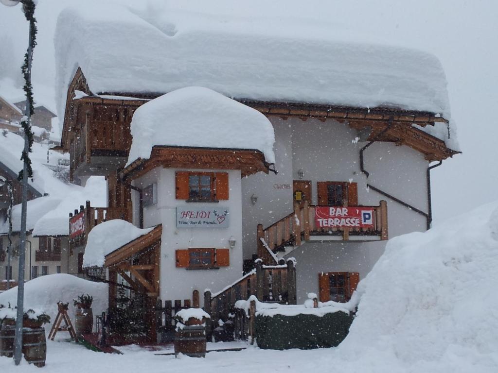 a building with snow on the top of it at Chalet Heidi in Arabba