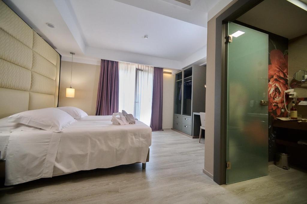 Postel nebo postele na pokoji v ubytování PARK HOTEL LE DUNE DI GIOVINO