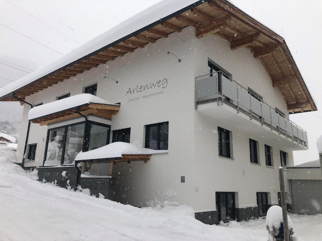 a snow covered building with a balcony on it at Arlenweg in Sankt Anton am Arlberg