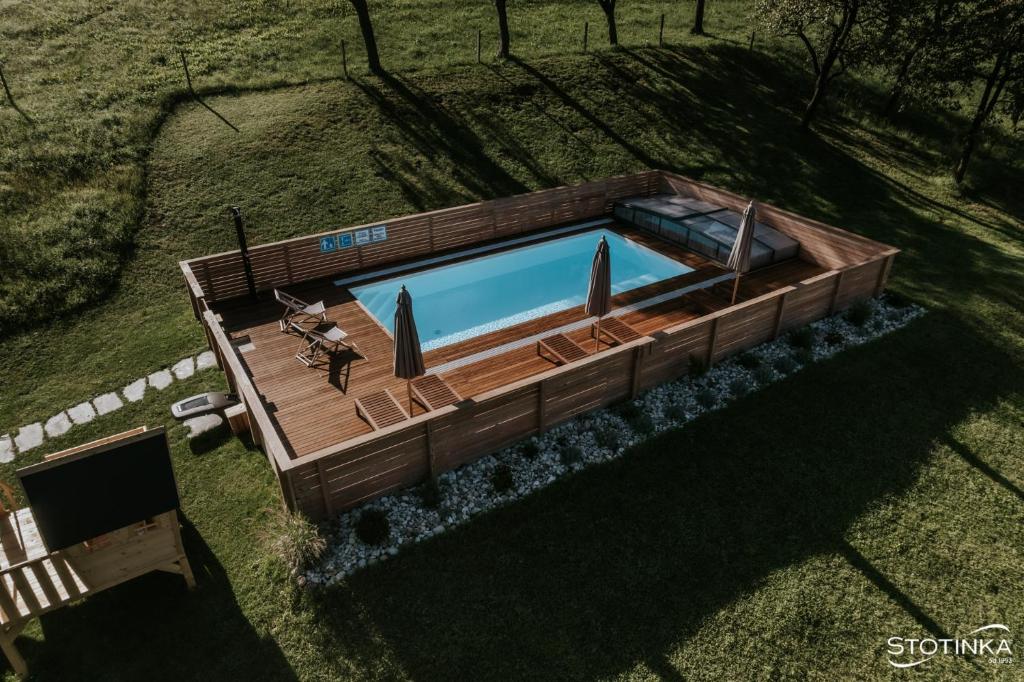 an overhead view of a swimming pool with a wooden deck at Domačija Metul in Luče