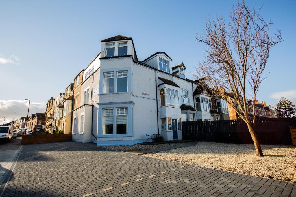 a white house on the side of a street at Stay Coastal in Whitley Bay