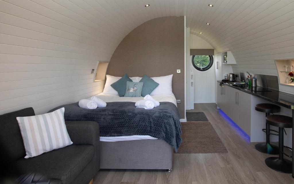 a bedroom with a bed and a couch in a room at Millview Meadow Retreats in Great Yarmouth