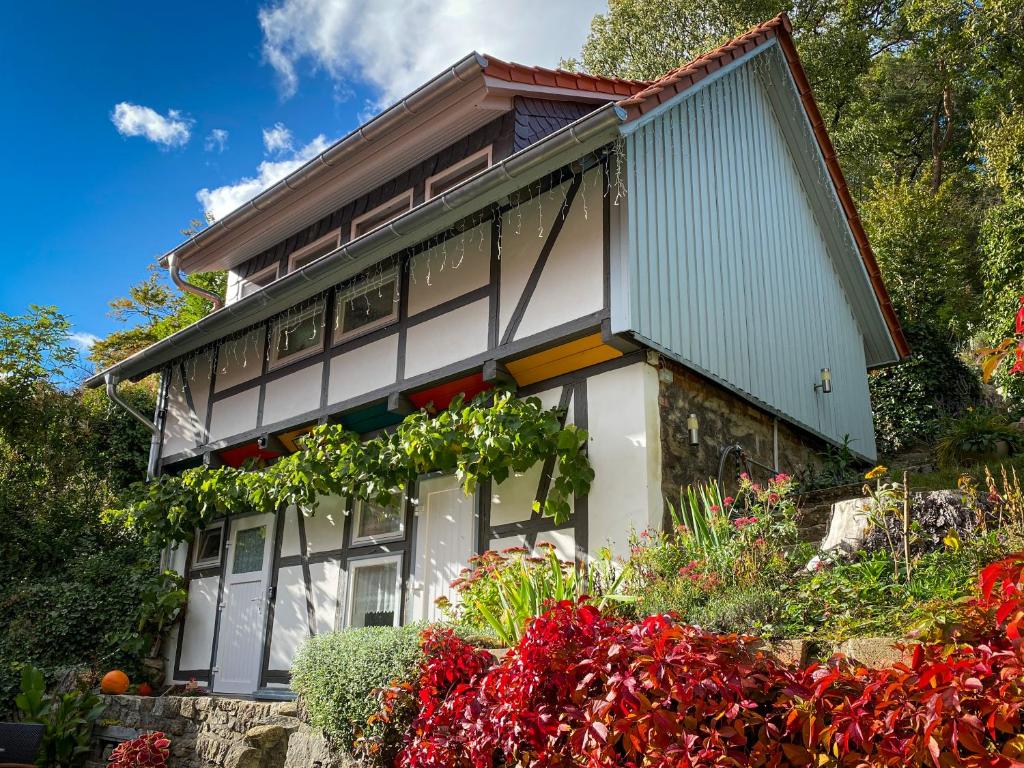 a house with flowers in front of it at Harz im Glück - Fachwerkhaus für zwei in Wernigerode in Wernigerode