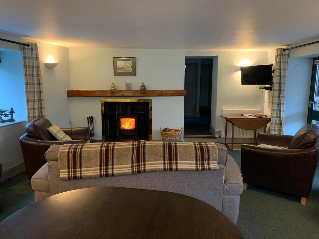 a living room with a couch and a fireplace at Ashley Croft in Skipton