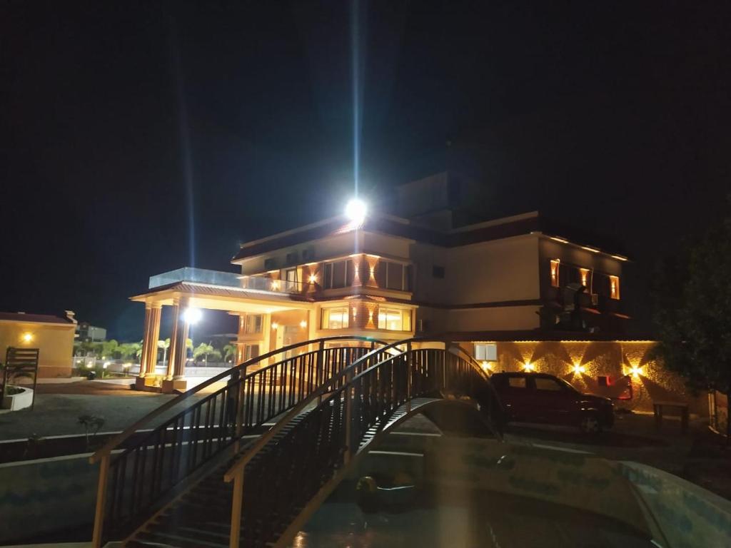 a building with a bridge in front of it at night at Flamingo Club and Resort Una 3 Km Away from Diu Check Post in Diu