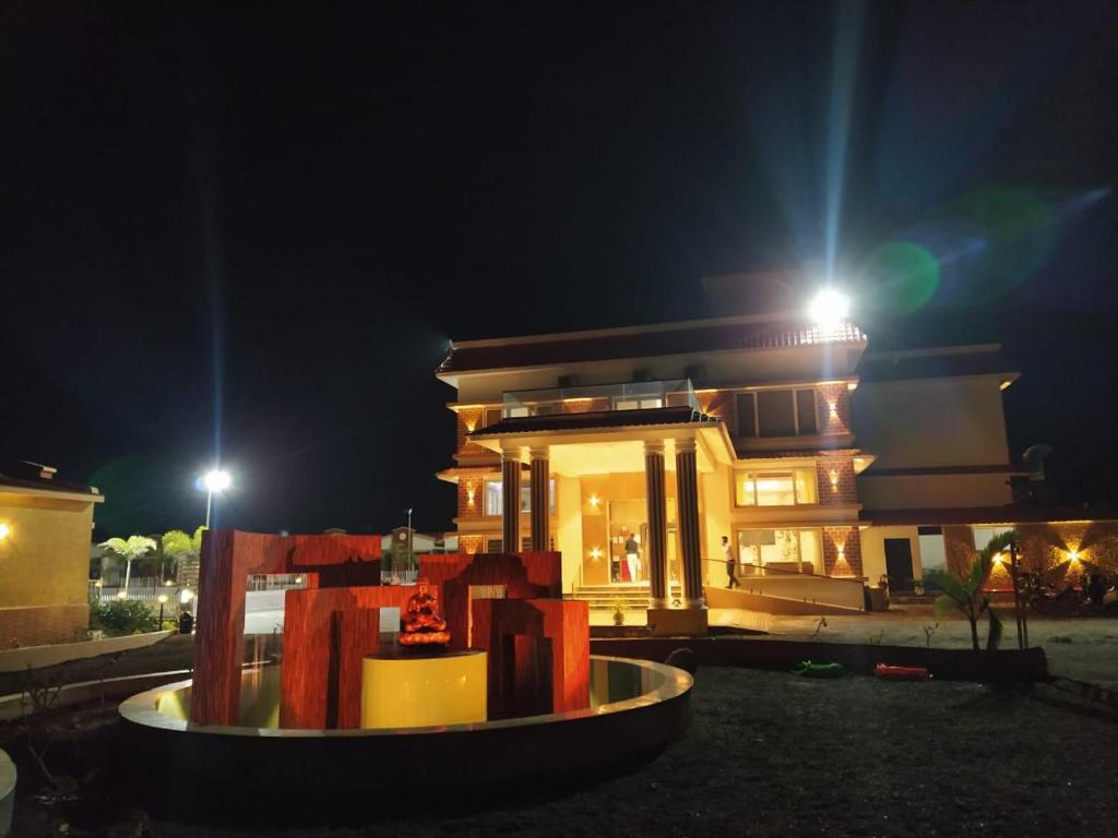 a house at night with a sculpture in front of it at Flamingo Club and Resort Una 3 Km Away from Diu Check Post in Diu