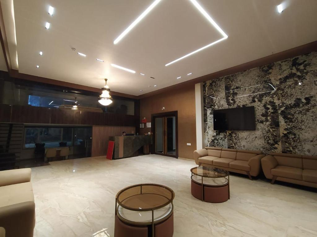 a large lobby with a couch and a tv in it at Flamingo Club and Resort Una 3 Km Away from Diu Check Post in Diu