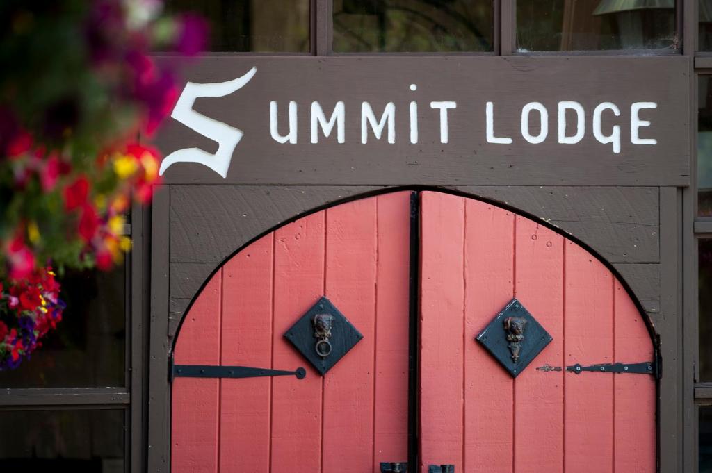 a red door with the words summit lodge on it at Summit Lodge in Killington