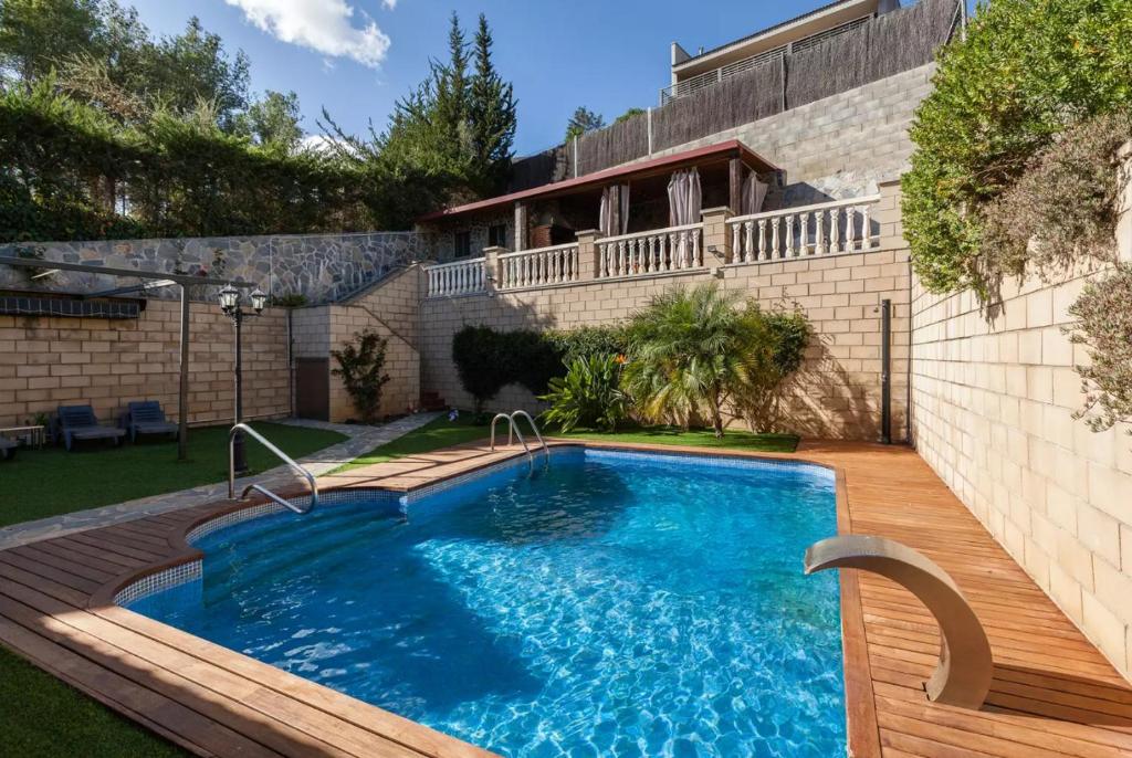 a swimming pool in the backyard of a house at Casa Lourdes in Canyelles