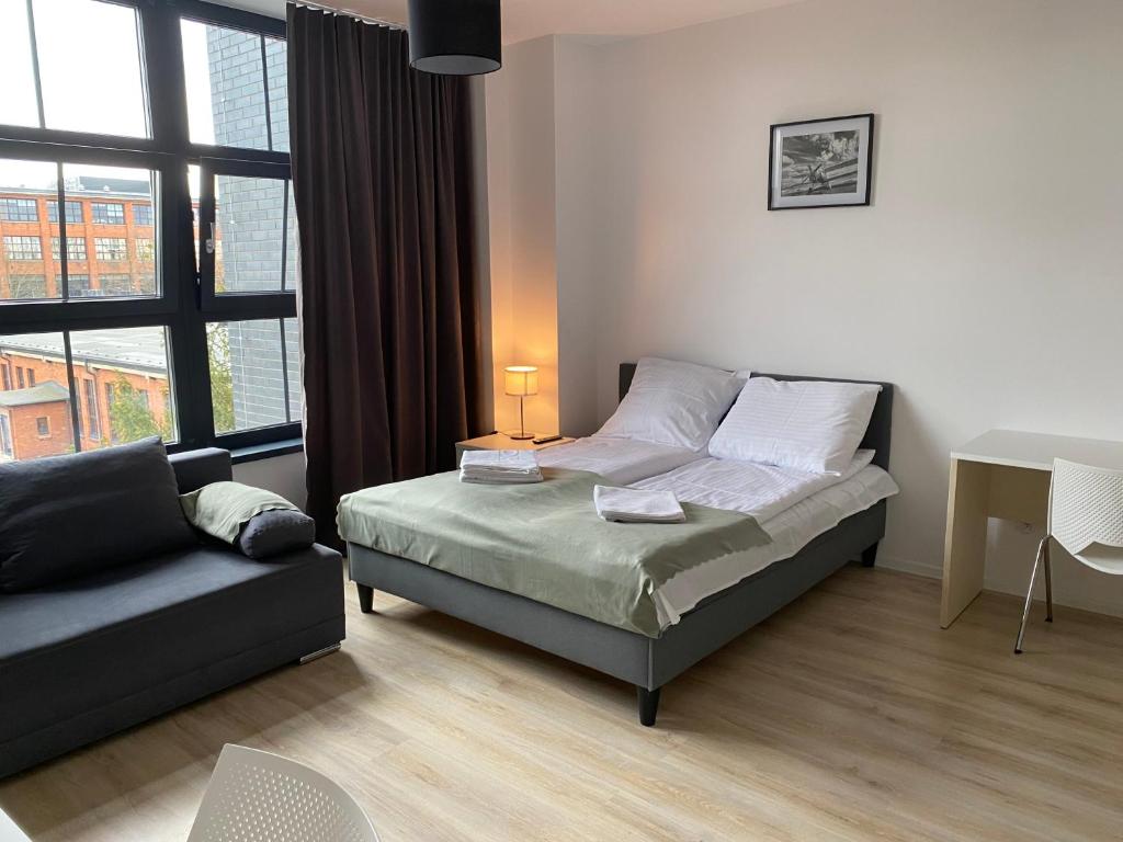 Posteľ alebo postele v izbe v ubytovaní SleepWell Apartments