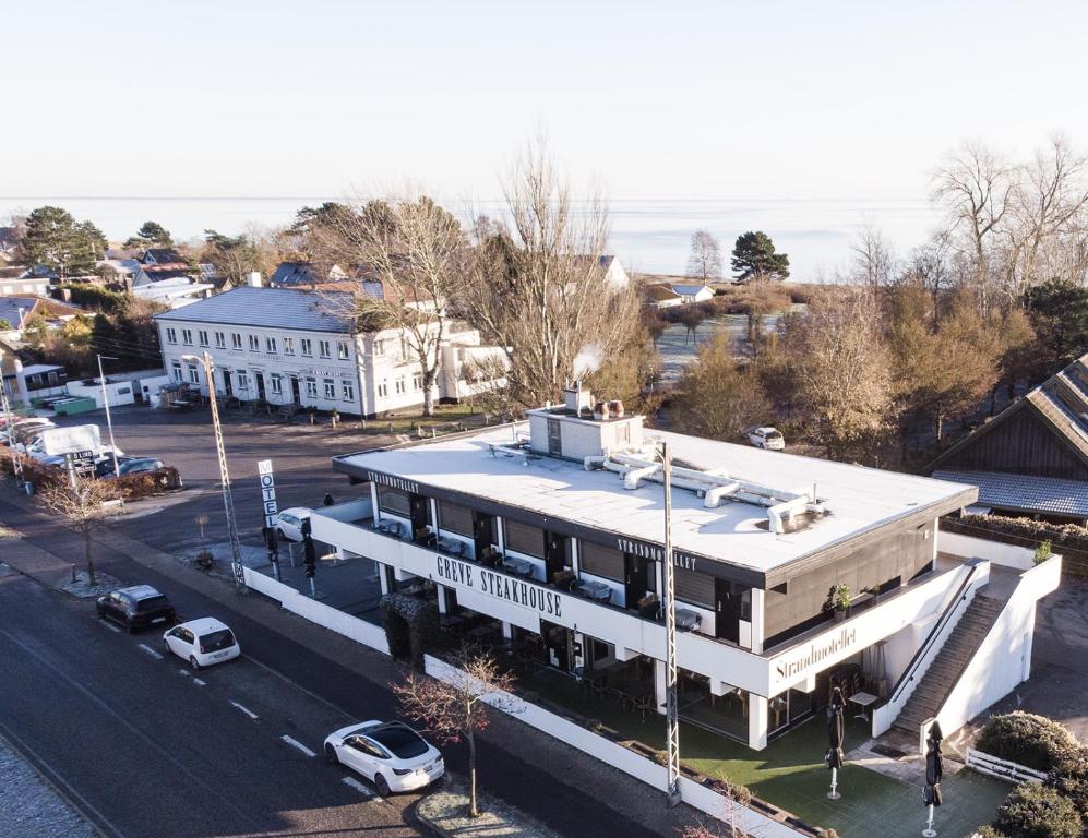 an aerial view of a white building with a street at Strandmotellet in Greve