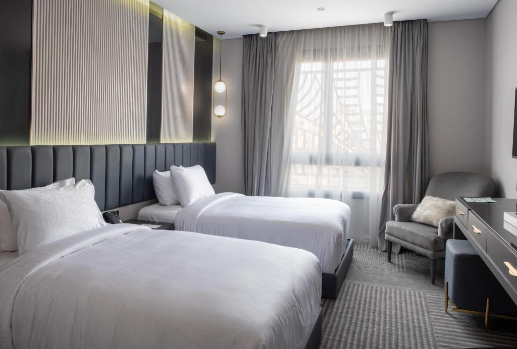 Postel nebo postele na pokoji v ubytování Triumph Luxury Hotel
