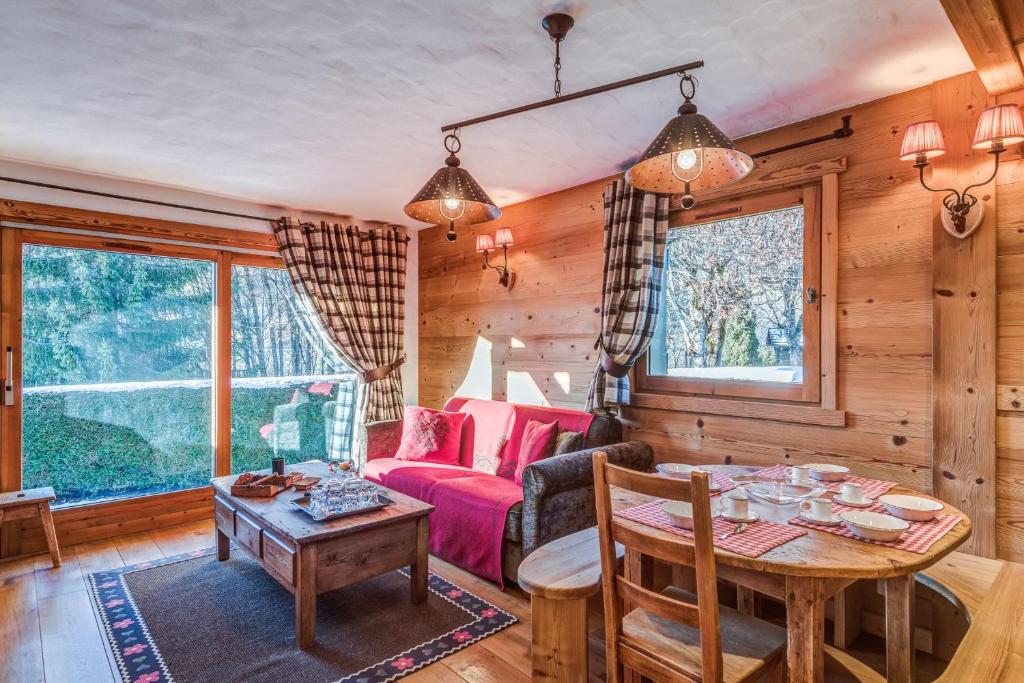 ein Wohnzimmer mit einem Tisch und einem Sofa in der Unterkunft Charming flat in a chalet in Megève - Welkeys in Megève