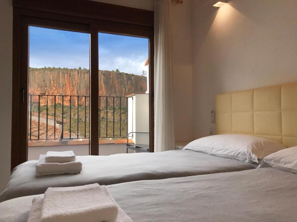 a bedroom with a bed with a view of a canyon at Casa Rural La Cambreta - Chulilla in Chulilla