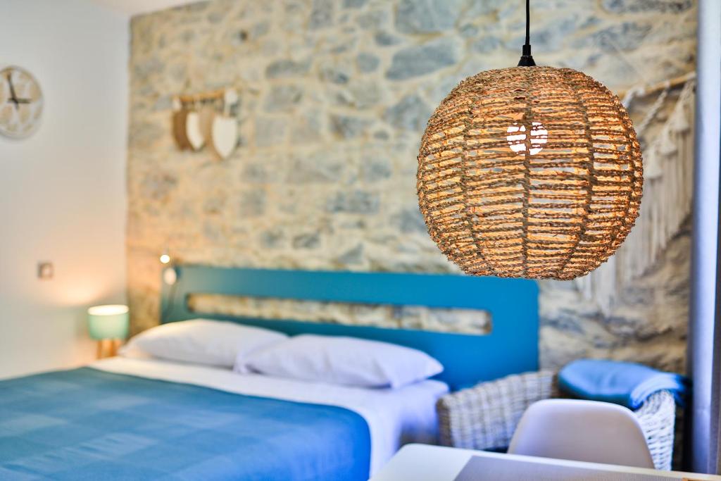 a bedroom with a bed and a chandelier at Le Vallaya Suites & Spa in Menton