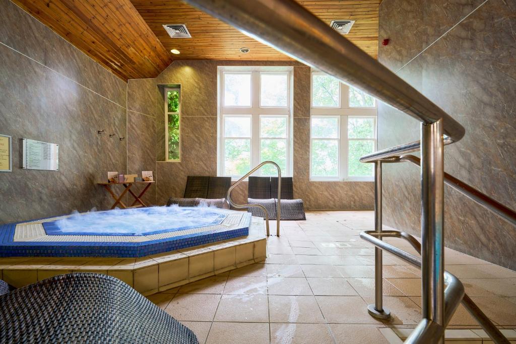 a large room with a bed and a staircase at Stirling Highland Hotel- Part of the Cairn Collection in Stirling