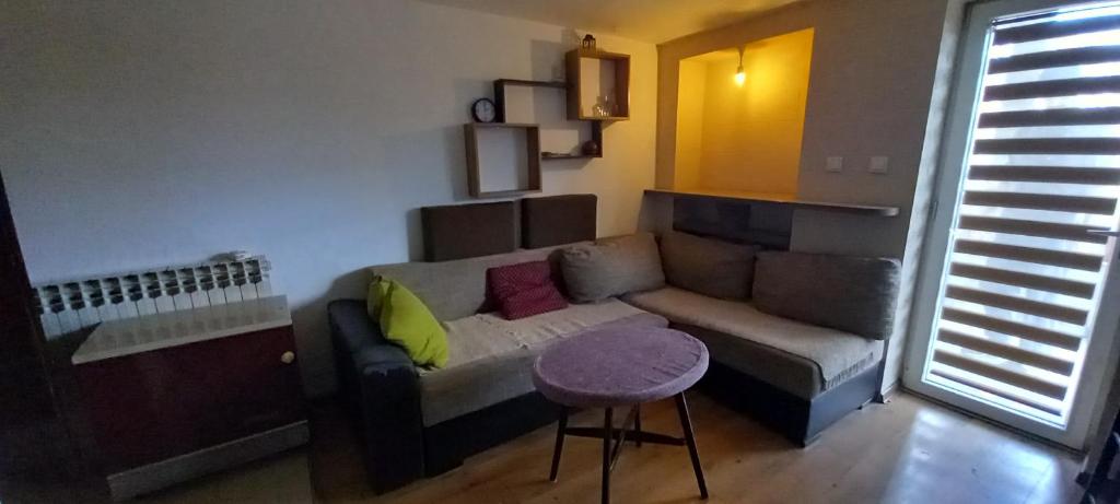 - un salon avec un canapé et une table dans l'établissement GM Place apartment 60 m2, à Gornji Milanovac
