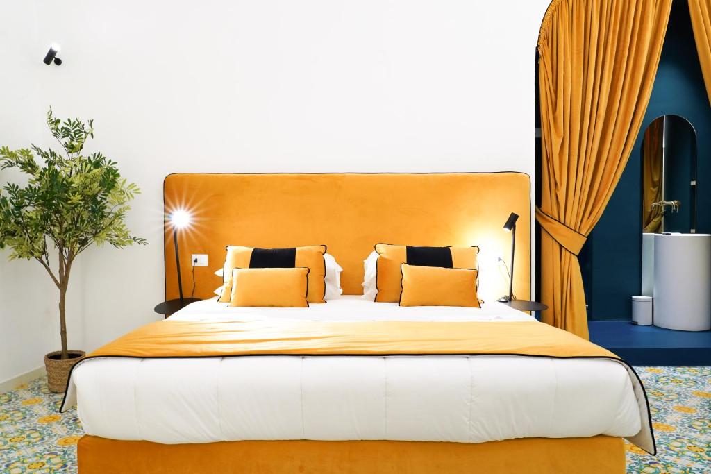 a bedroom with a large bed with orange pillows at relais metis in Naples