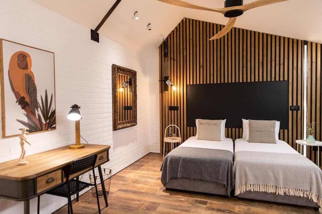 a bedroom with a large bed and a desk at Dark Studio in São Roque