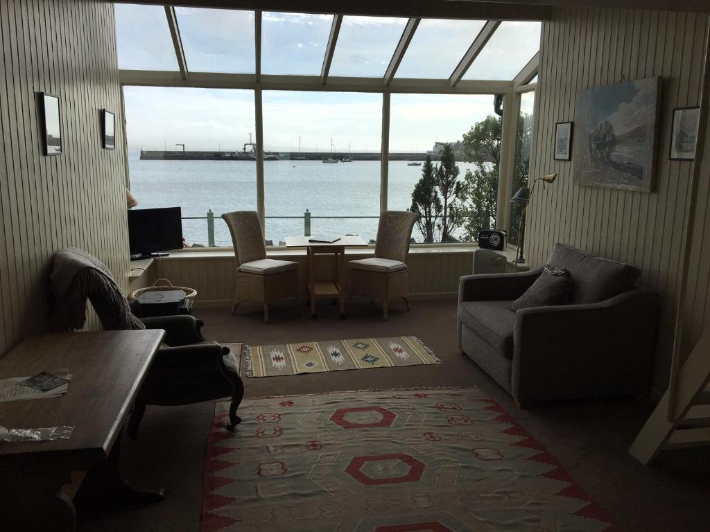 a living room with a view of the water at The Baby House @ Wood Quay, Carlingford in Carlingford