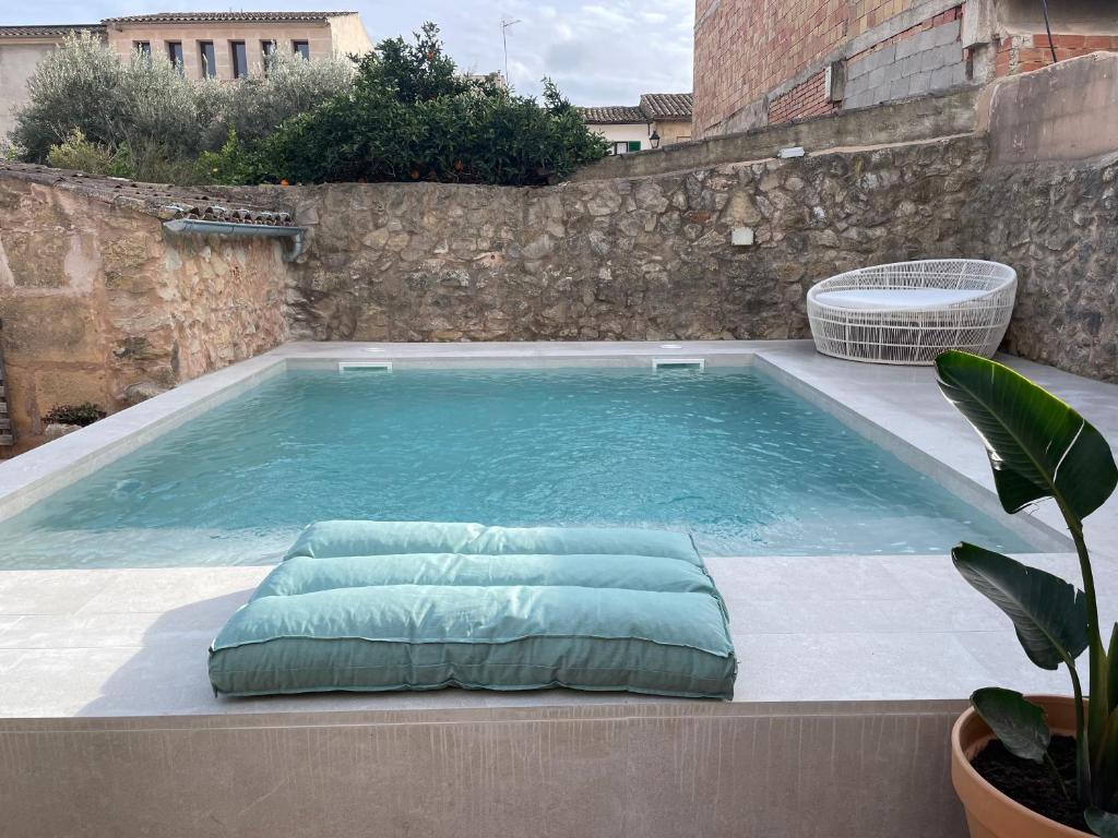 a swimming pool with a pillow in the middle at Ca Sa Padrina in Vilafranca de Bonany