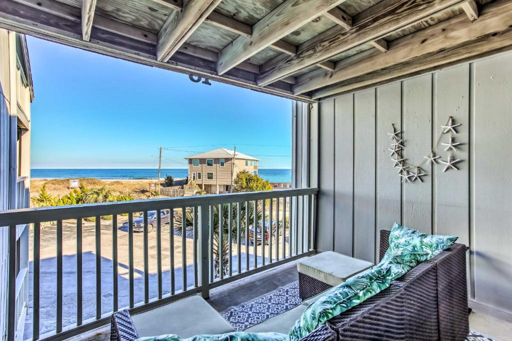a balcony with a couch and a view of the ocean at Condo with Pool Access - Walk to Beach! in Carolina Beach
