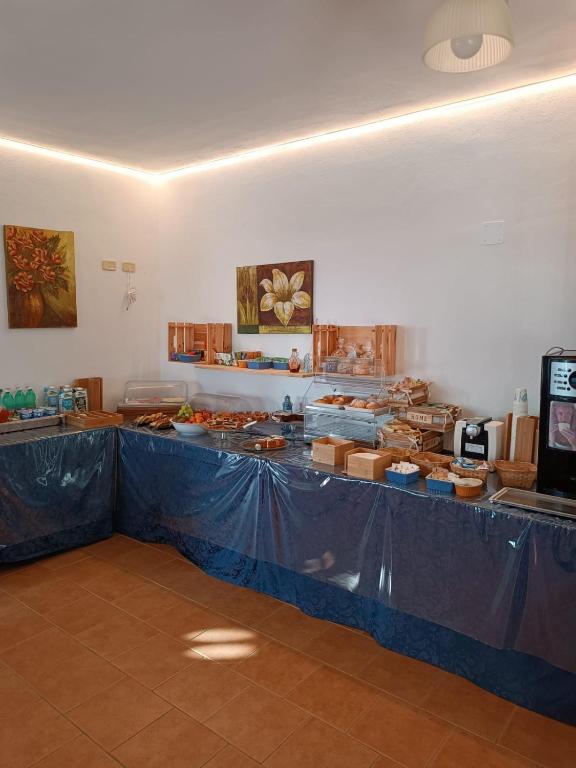 a room with a blue table with food on it at Althea Village Residence in Vieste