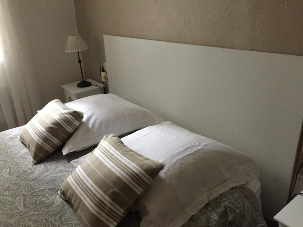 a bedroom with two white pillows on a bed at Maison au bord de mer in Saintes-Maries-de-la-Mer