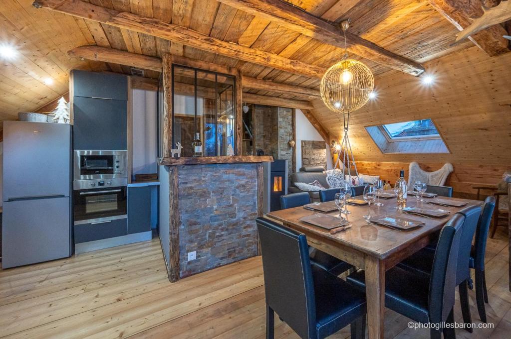 a kitchen and dining room with a table and chairs at Appartement de 3 chambres avec terrasse amenagee et wifi a Orcieres in Orcières