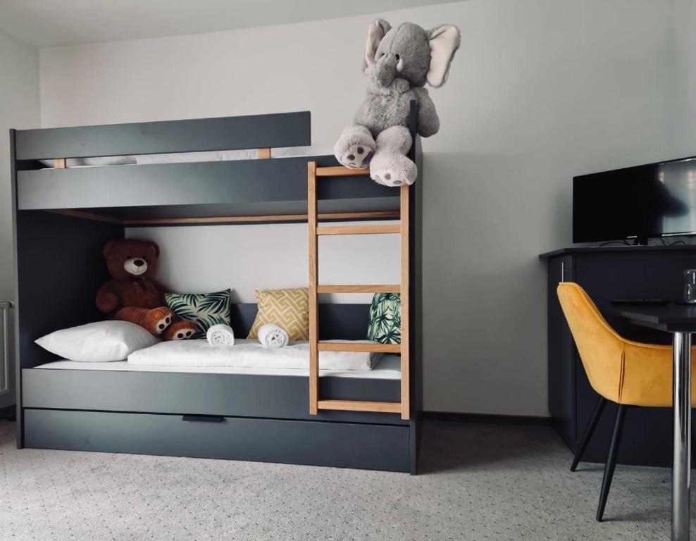a bunk bed with a stuffed animal sitting on top of it at Thermenhof Lutzmannsburg - Inklusive Thermeneintritt in Lutzmannsburg