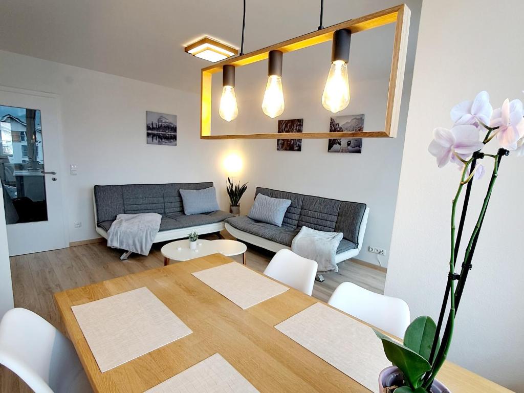 a living room with a table and a couch at Schmidis Ferienwohnung Sonthofen in Sonthofen