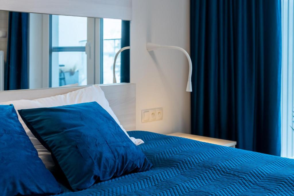 Łóżko lub łóżka w pokoju w obiekcie Sunrise Apartament