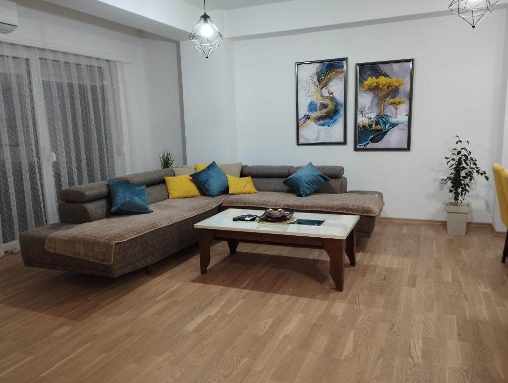 a living room with a couch and a coffee table at Sofija Apartment in Kumanovo