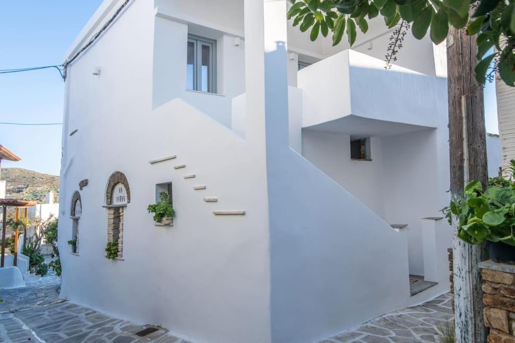 a white house with stairs up to the second floor at PG Houses in Kalloni Village - PHouse in Kalloni Tinou