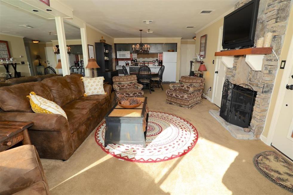 a living room with a couch and a fireplace at Seven Springs 1 Bedroom Premium Condo, Ski In Ski Out condo in Champion