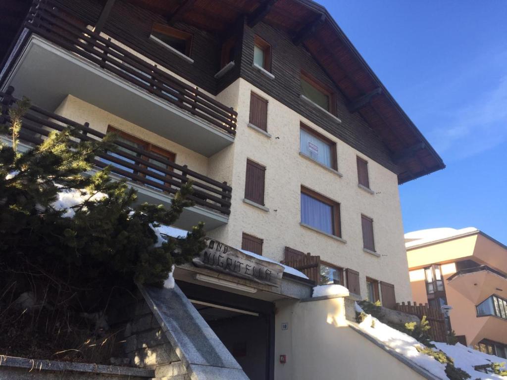 a building with a balcony on the side of it at NIGRITELLA in Madonna di Campiglio